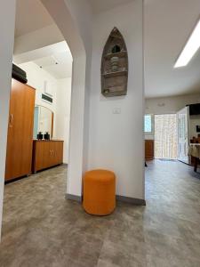 an empty room with an orange stool in the middle at Apartment Ambretta in Savudrija