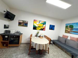 a living room with a table and a couch at Apartment Ambretta in Savudrija