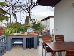 a patio with a sink and a table and chairs at Apartment Ambretta in Savudrija