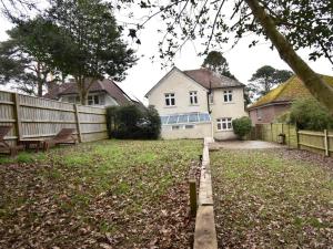 a yard with a fence and a house at 4 Bed in Swanage oc-dc046 in Studland