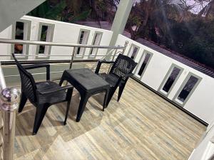 two chairs and a table on a balcony at Diving Nest in Trincomalee