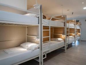 a group of bunk beds in a room at mundoalbergue in Santiago de Compostela