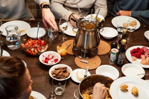 a group of people sitting around a table with food at Almresort Sonnenalpe Nassfeld in Sonnenalpe Nassfeld +53 photos