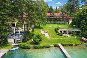 an aerial view of a house with a river at Hotel Villa Rainer in Pörtschach am Wörthersee