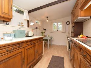 a kitchen with wooden cabinets and a counter top at 1 Bed in Bridport oc-dc085 in Loders