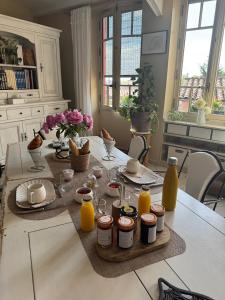 a kitchen table with food and orange juice on it at Bienvenue chez Sylvie in Lyon