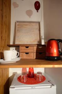 a shelf with two glasses on top of a stove at Bienvenue chez Sylvie in Lyon