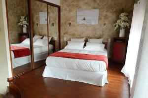 a bedroom with two beds and a large mirror at Bienvenue chez Sylvie in Lyon