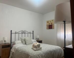 a bedroom with a bed with a blanket and a lamp at Apartamento en Colombres in Colombres