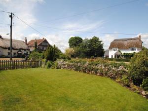 a garden with flowers and houses in the background at 1 Bed in Wareham oc-dc153 in Wool