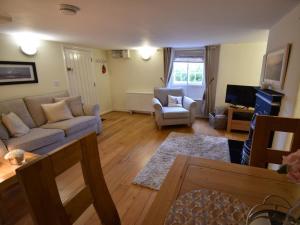 a living room with a couch and a tv at 1 Bed in Wareham oc-dc153 in Wool