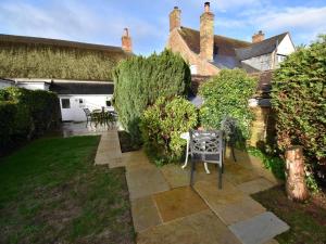 a garden with a table and chairs in front of a building at 1 Bed in Wareham oc-dc153 in Wool +7 photos