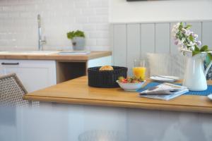 a table with a bowl of food and a glass of orange juice at Ferienwohnung Zweites Zuhause in Büsum