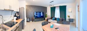 a living room with a couch and a tv at AmurResidence 64 Sauna Parking Barbeque in Iaşi