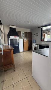 a large kitchen with a counter in a room at Escadaria Vila Rica Pousada & Hostel in Ouro Preto