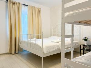 a white bedroom with a bunk bed and a window at AmurResidence 64 Sauna Parking Barbeque in Iaşi +51 photos