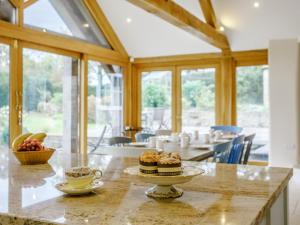 a dining room with a table with cupcakes on it at 5 Bed in Wincanton oc-79062 in Hilton +22 photos