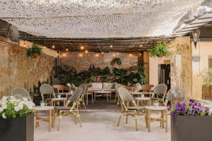 a patio with tables and chairs and plants at La França Hotel Boutique in Barcelona