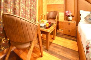 a bedroom with a table and a chair and a bed at Hotel Park Plaza Srinagar in Srinagar +28 photos