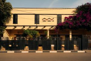 a building with a fence in front of it at Rwanda African Art Museum in Nyabisindu