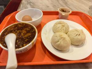 a tray with a plate of dumplings and a bowl of soup at Mercure Beijing Tiananmen Square Qianmen Street in Beijing