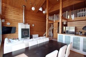 a living room with a white couch and a table at Päijänteen Helmi 2 in Jämsä +9 photos