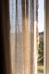 a close up of a curtain in a window at Hotel Linette in Aumont-Aubrac