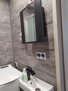 a bathroom with a sink and a mirror at Jolanta's apartment in Hajnówka