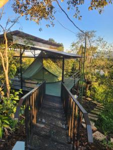 a wooden bridge leading to a house with a tent at Ararat Eco Farm in Coto Brus +14 photos