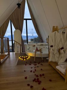 a room with a tub and roses on the floor at Lakeside Villas & Jacuzzi Suites in Shirokë +63 photos