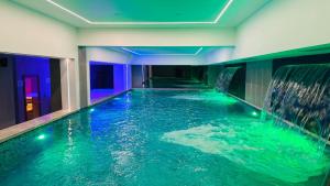 a swimming pool in a hotel with a waterfall at Quaint Hotel Erbil in Erbil