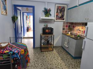 a kitchen with a bed and a sink in a room at Studio By the Beach in Saronida