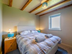 a bedroom with a bed with two pillows and a window at 2 Bed in Lancaster oc-82857 in Beetham