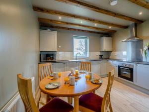 a kitchen with a wooden table with chairs and a dining room at 2 Bed in Lancaster oc-82857 in Beetham