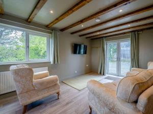 a living room with two chairs and a couch at 2 Bed in Lancaster oc-82857 in Beetham
