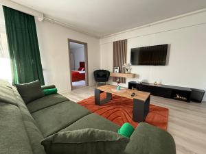 a living room with a couch and a coffee table at IDDA Concept 3 in Târgu-Mureş
