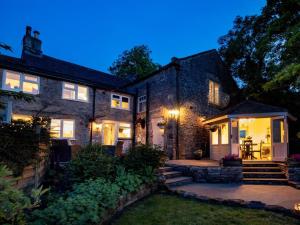 a stone house with a patio at night at 4 Bed in Leyburn oc-83260 in Middleham
