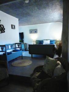 a living room with a bed and a couch at Suite romance in Froid-Chapelle