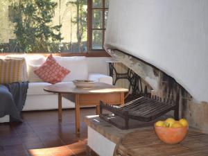 a living room with an outdoor oven with a table at El Jardí de Tamariu in Tamariu +29 photos