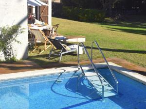 a swimming pool with a slide in a yard at El Jardí de Tamariu in Tamariu