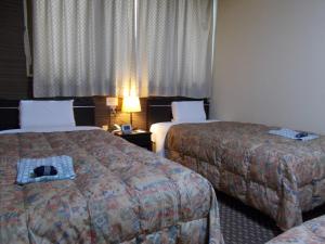 Postel nebo postele na pokoji v ubytování Hotel Matsuyama Hills