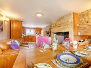 a living room with a wooden table and a fireplace at 2 Bed in Hexham oc-88214 in Yarrow