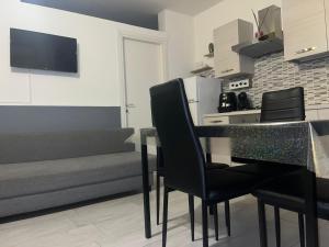a living room with a table and chairs and a couch at A picciridda house in Catania