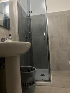 a bathroom with a shower with a sink and a toilet at A picciridda house in Catania