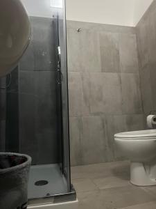 a bathroom with a shower and a toilet at A picciridda house in Catania