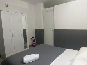 a bedroom with a bed with a towel on it at A picciridda house in Catania