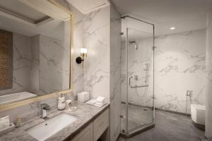 a bathroom with a sink and a glass shower at The Greenberry Mountain Resort Narkanda in Nārkanda +25 photos