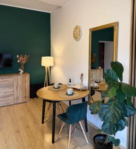 a living room with a table and a plant at Pod Aniołami in Wałbrzych +11 photos