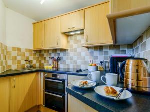 a kitchen with two plates of food on a counter at 1 Bed in Holmfirth oc-91106 in Cartworth