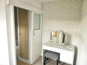 a bathroom with a white desk and a mirror at 1 Bed in Holmfirth oc-91106 in Cartworth +6 photos